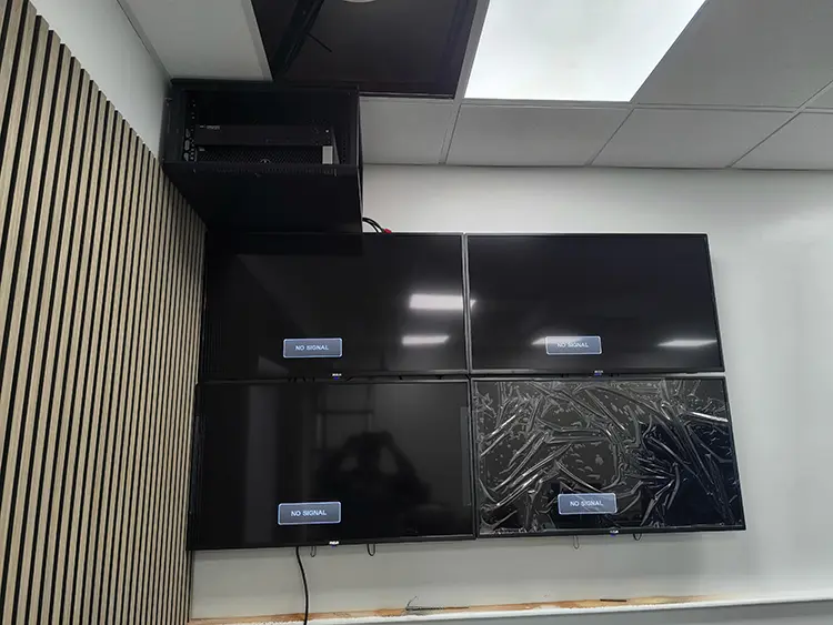 Multi-screen CCTV monitoring station and server rack installation in a London business office